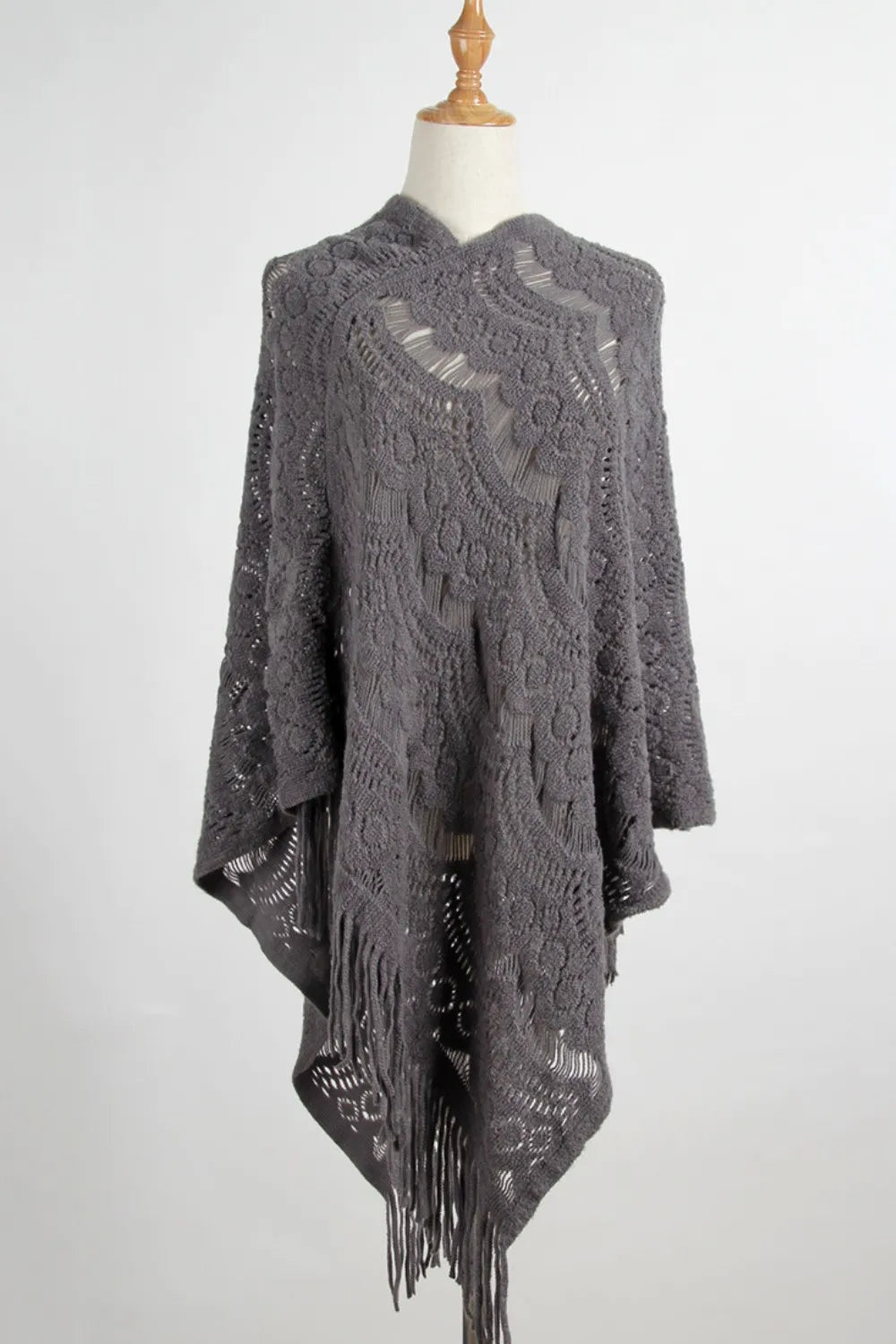 gray knitted poncho with fringe