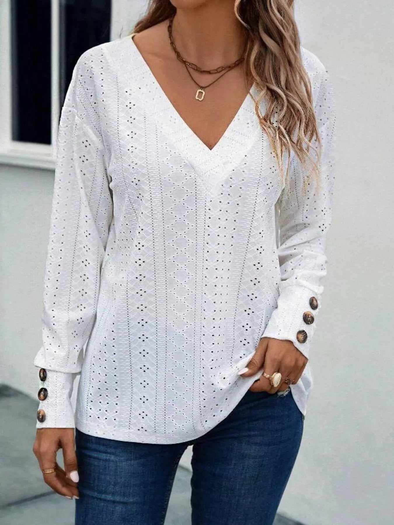 women’s white long‑sleeve top with button details