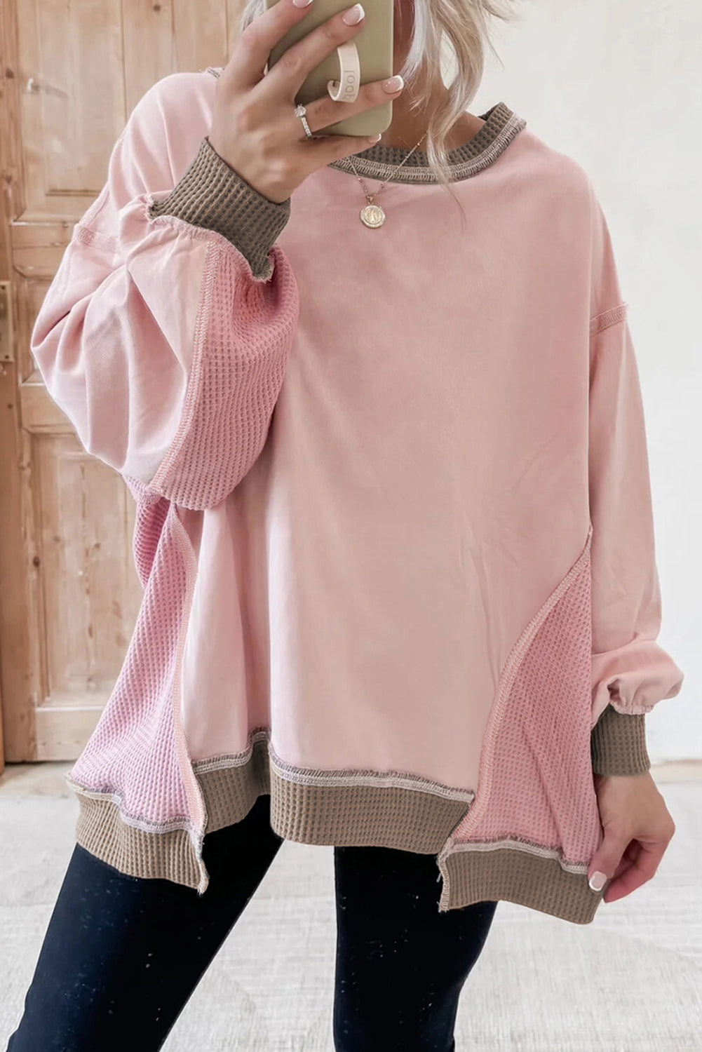 women's pink sweater with textured sleeves and hem